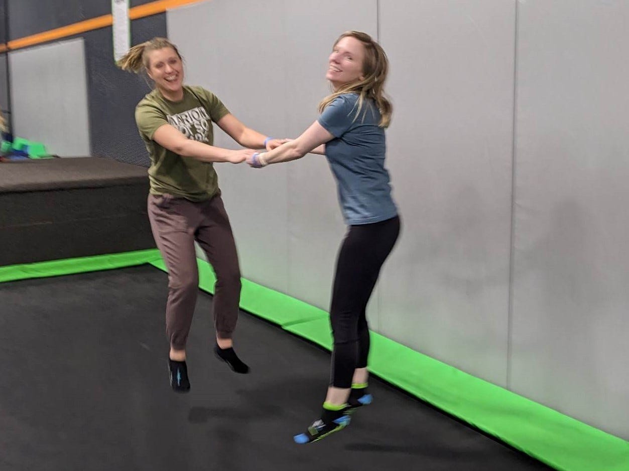 Two women jumping on a tampoline